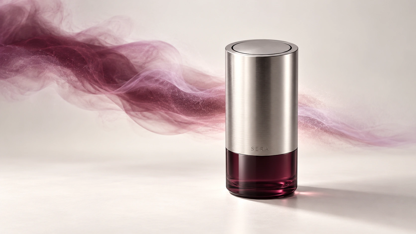 SERA scent device in brushed silver and smoked burgundy glass, surrounded by a ribbon of mist